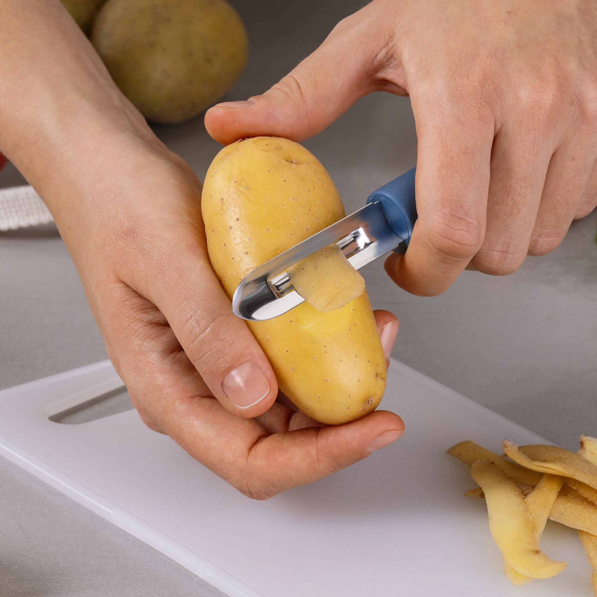 Skreller rustfritt stål 7 cm blå Essential bakside