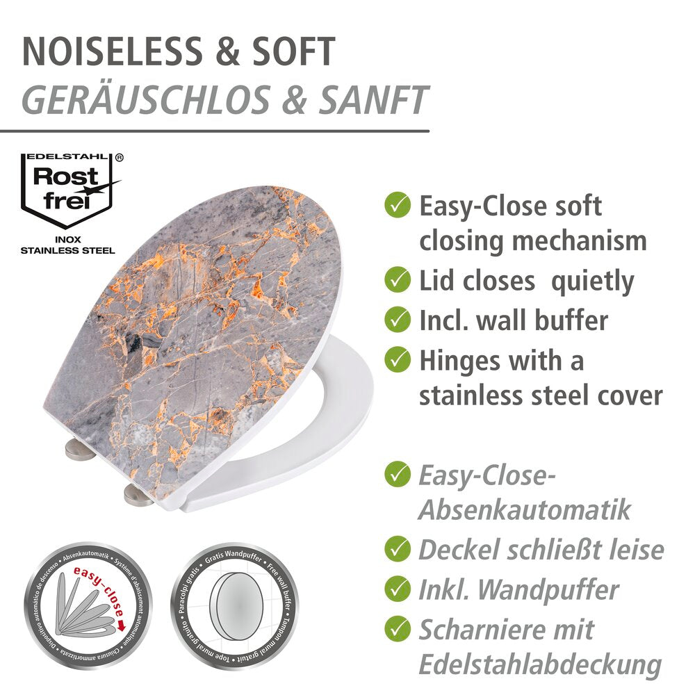 Nærbilde av kobberfargede detaljer på toalettsete grå marmor med relieff, duroplast med softclose